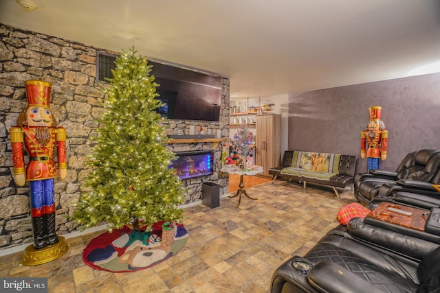 living room with a stone fireplace