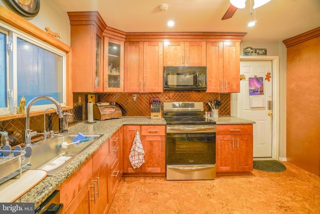 kitchen with backsplash, light stone counters, ceiling fan, sink, and electric range