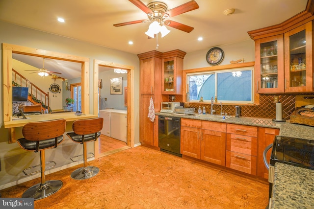 kitchen featuring dishwasher, sink, light stone counters, light colored carpet, and decorative backsplash