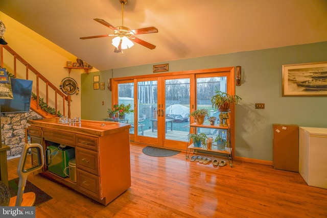 office area with ceiling fan, french doors, and light hardwood / wood-style flooring