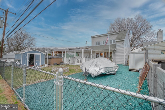 back of property with a pergola, a yard, and a shed