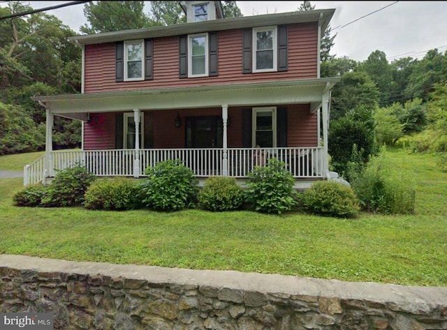 view of front of house with covered porch and a front yard