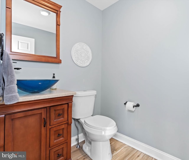 bathroom featuring hardwood / wood-style floors, vanity, and toilet