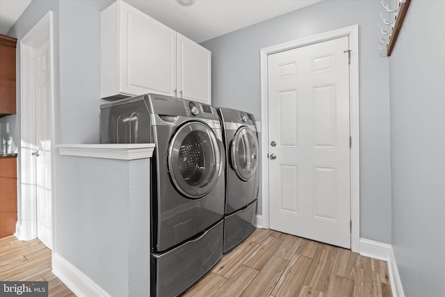 laundry room featuring cabinets and independent washer and dryer