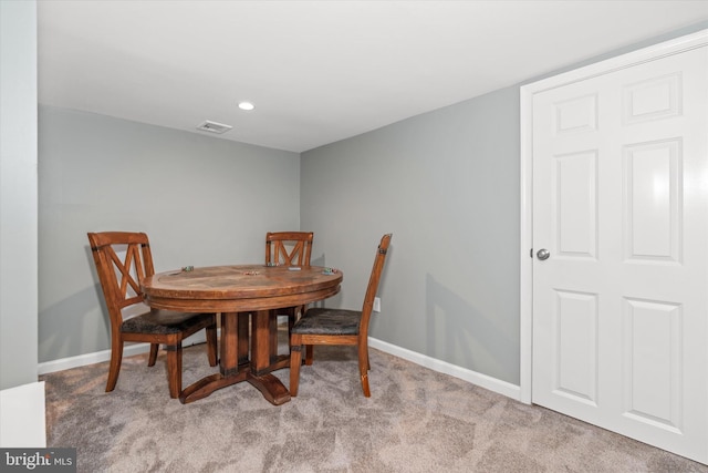 dining area featuring light colored carpet