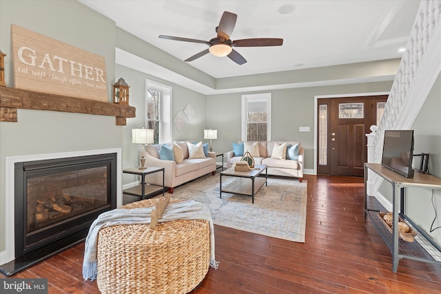 living room featuring dark hardwood / wood-style floors and ceiling fan