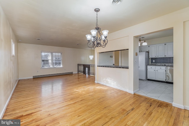 unfurnished living room with an inviting chandelier, light wood-type flooring, and a baseboard radiator