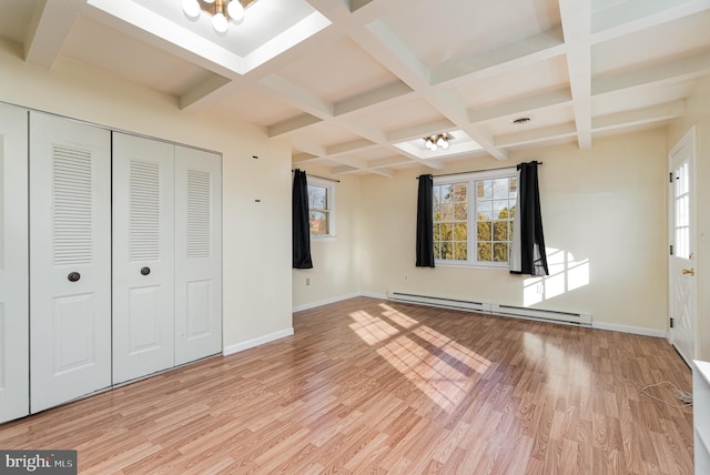 unfurnished bedroom with coffered ceiling, a baseboard heating unit, light wood-type flooring, beamed ceiling, and a chandelier