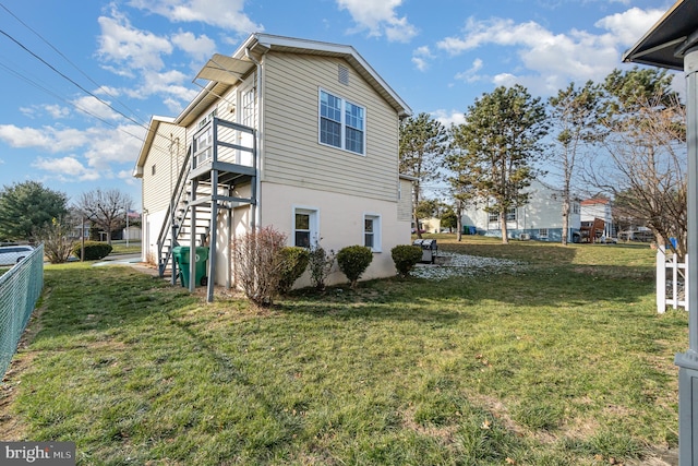 view of side of home with a yard