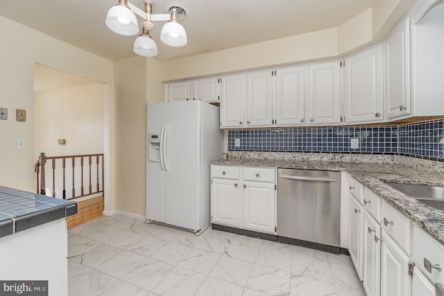 kitchen featuring dishwasher, white cabinetry, white fridge with ice dispenser, and hanging light fixtures