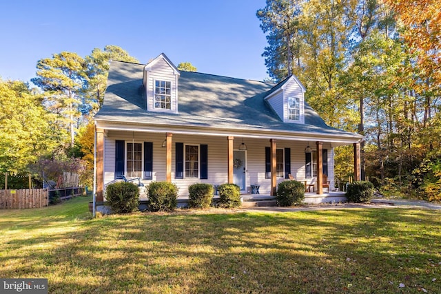 cape cod-style house with a front yard