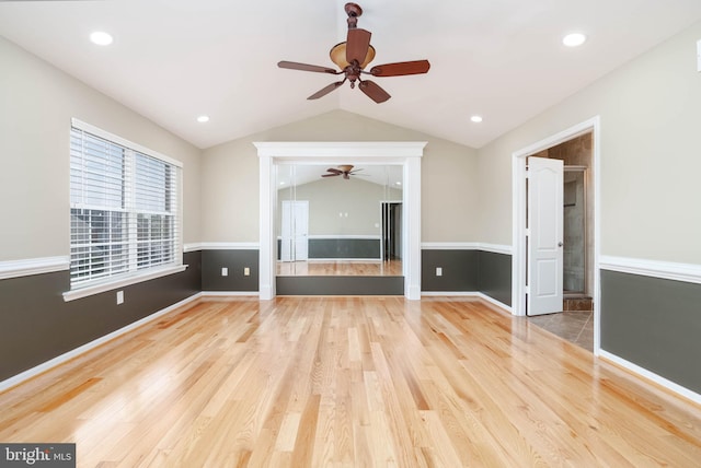 unfurnished living room with hardwood / wood-style floors, ceiling fan, and lofted ceiling