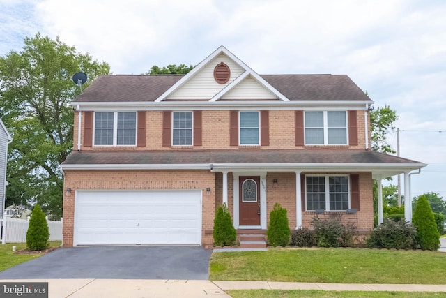 view of front of house featuring a front lawn and a garage