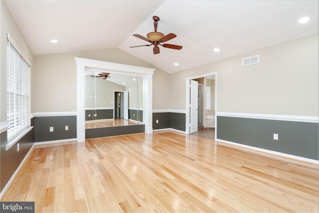 unfurnished living room with ceiling fan, light wood-type flooring, and lofted ceiling