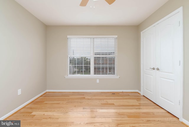 unfurnished bedroom with ceiling fan, light hardwood / wood-style floors, and a closet