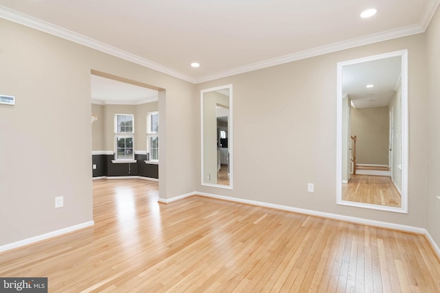 unfurnished room featuring crown molding and light hardwood / wood-style flooring