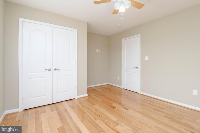 unfurnished bedroom with light wood-type flooring, a closet, and ceiling fan