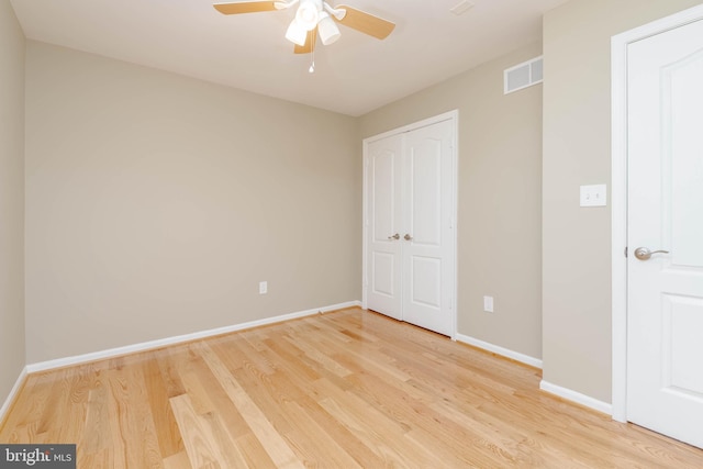 unfurnished bedroom with ceiling fan and hardwood / wood-style flooring