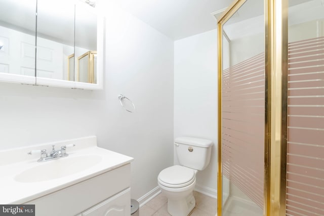 bathroom with tile patterned flooring, vanity, toilet, and a shower with shower door