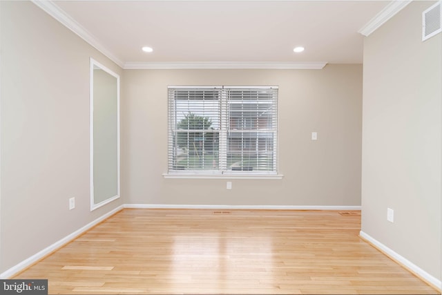 empty room with light hardwood / wood-style floors and ornamental molding