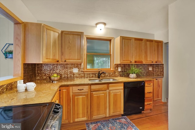 kitchen with sink, range, black dishwasher, and light wood-type flooring