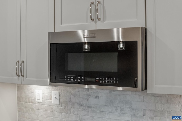 room details with backsplash and white cabinetry