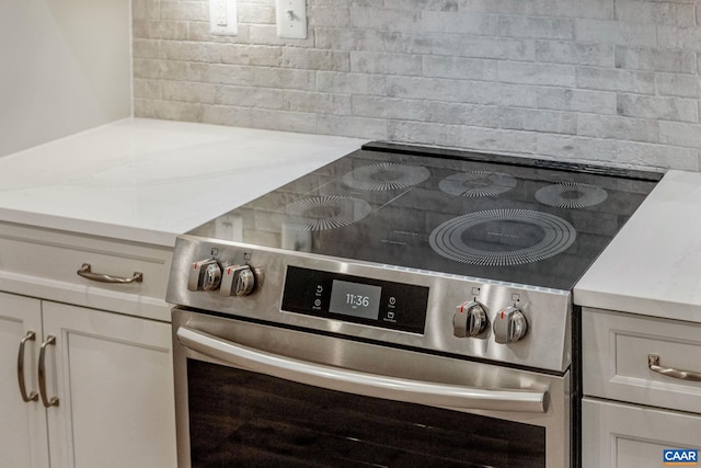 interior details featuring high end range and white cabinets