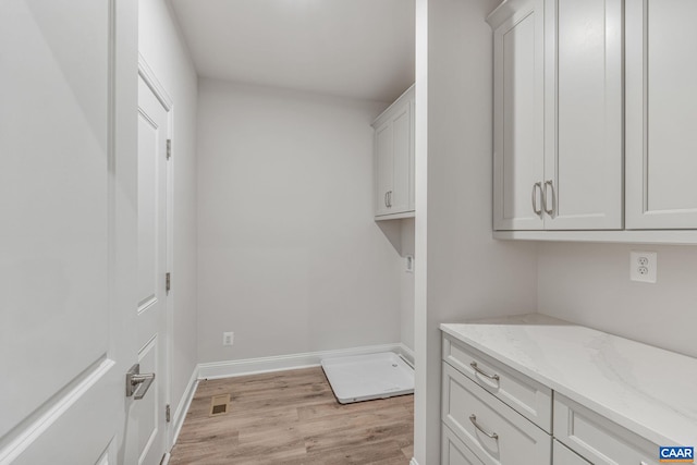 washroom with light hardwood / wood-style flooring