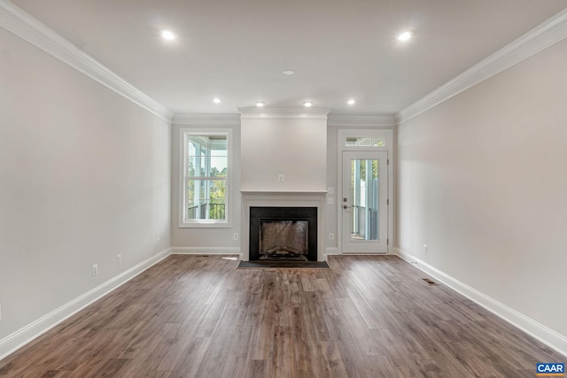 unfurnished living room with crown molding and hardwood / wood-style flooring