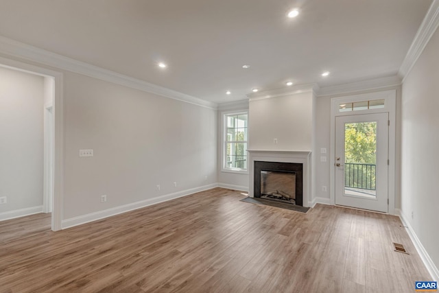 unfurnished living room featuring crown molding and light wood-type flooring