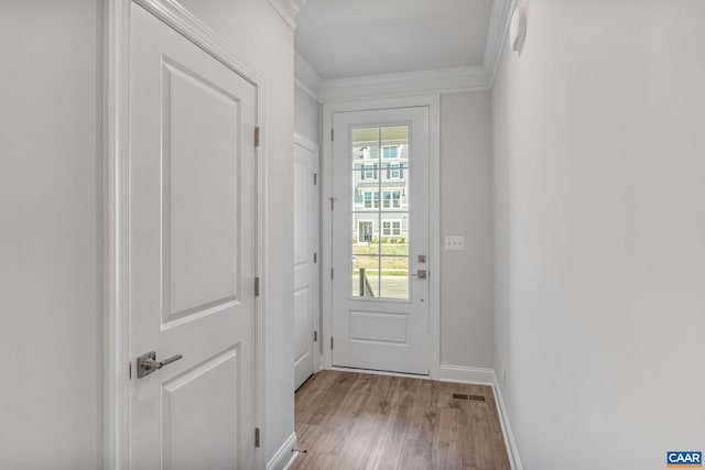 entryway featuring light hardwood / wood-style floors and crown molding