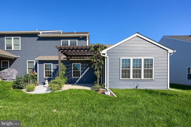 back of house with a lawn, a pergola, and a patio