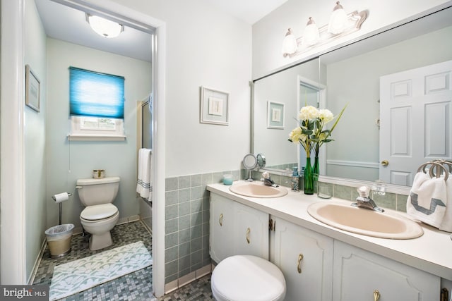 bathroom featuring vanity, tile walls, tile patterned flooring, toilet, and a shower with shower door