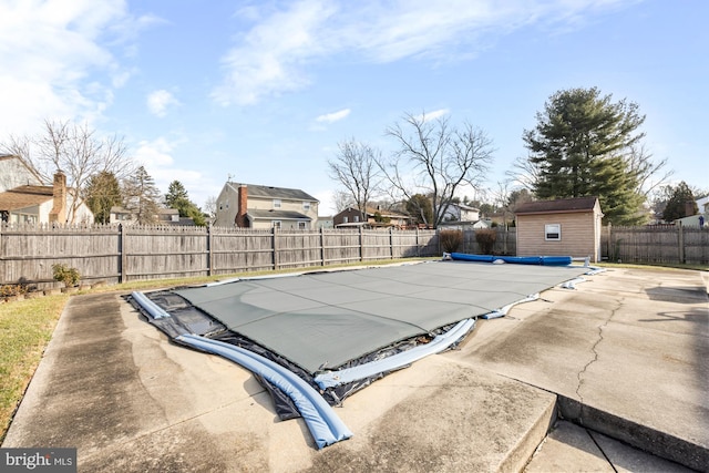 view of pool with a shed