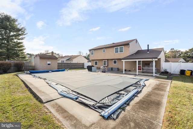 view of swimming pool featuring a yard and a patio