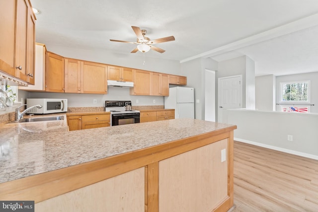 kitchen with light brown cabinets, white appliances, sink, light wood-type flooring, and kitchen peninsula