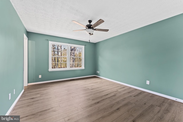 empty room with ceiling fan, a textured ceiling, and light hardwood / wood-style flooring