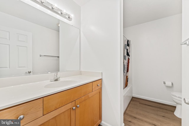 full bathroom with vanity, wood-type flooring, shower / tub combo, and toilet