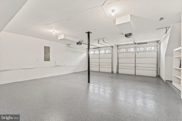 garage with electric panel and a garage door opener