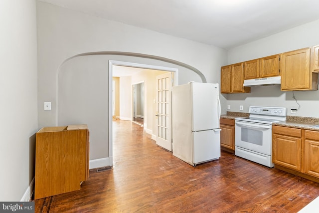 kitchen featuring dark hardwood / wood-style flooring and white appliances