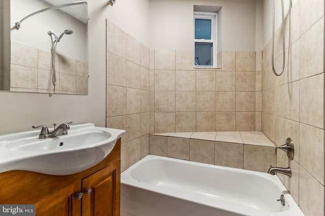 bathroom featuring vanity and tiled shower / bath combo