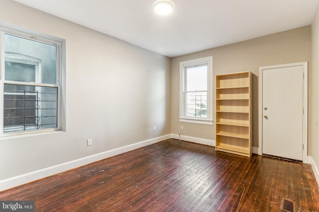 spare room featuring dark hardwood / wood-style floors