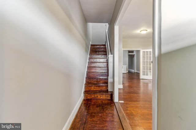 stairs featuring hardwood / wood-style floors