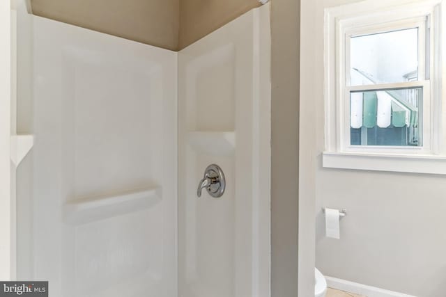 bathroom featuring toilet and a shower