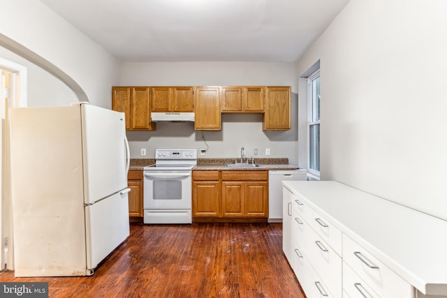 kitchen featuring sink, dark hardwood / wood-style floors, and white appliances