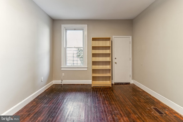 unfurnished bedroom with dark hardwood / wood-style flooring