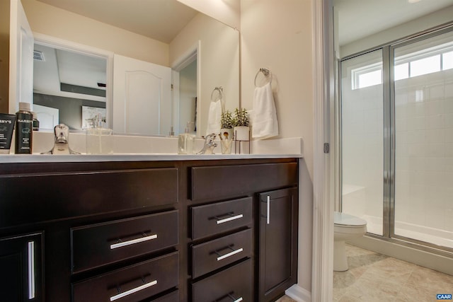 bathroom with tile patterned floors, vanity, toilet, and a shower with door