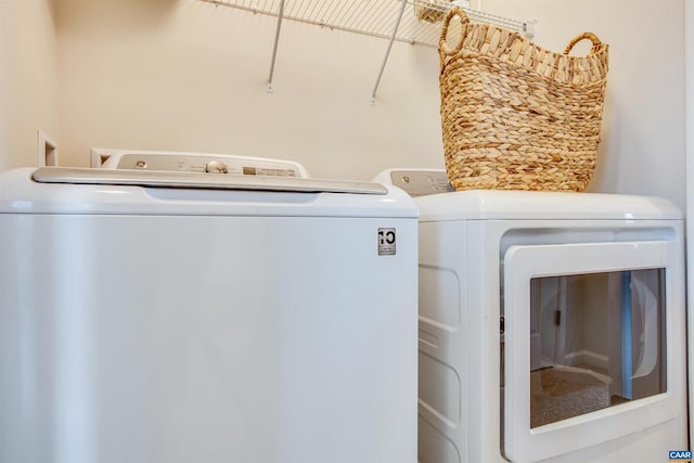 washroom featuring washer and clothes dryer