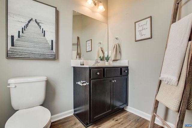 bathroom featuring hardwood / wood-style flooring, vanity, and toilet