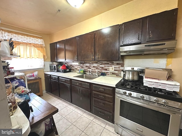 kitchen with sink, gas stove, and dark brown cabinetry